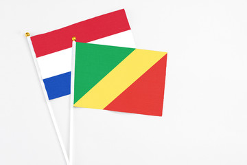 Republic Of The Congo and Paraguay stick flags on white background. High quality fabric, miniature national flag. Peaceful global concept.White floor for copy space.