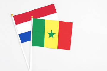 Senegal and Paraguay stick flags on white background. High quality fabric, miniature national flag. Peaceful global concept.White floor for copy space.