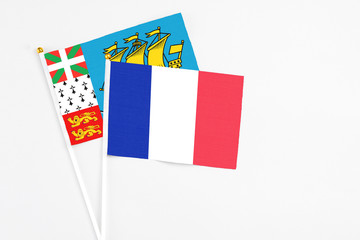 Wall Mural - France and Saint Pierre And Miquelon stick flags on white background. High quality fabric, miniature national flag. Peaceful global concept.White floor for copy space.