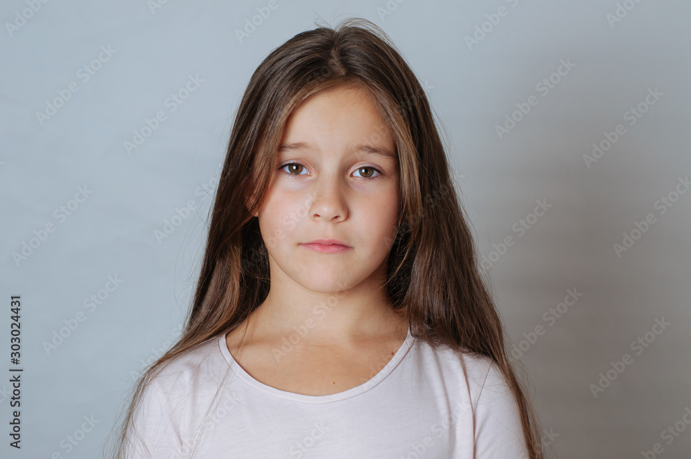 Emotional portrait of strong emotions tears of a little beautiful girl on a white background - obrazy, fototapety, plakaty 