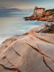Wall Mural - a lot of lines on the stones of coastlines with view to old castle in Livorno in Tuscany in Italy