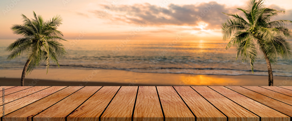 long wooden table with beach landscape blur background - obrazy, fototapety, plakaty 