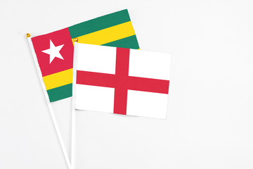 england and togo stick flags on white background. high quality fabric, miniature national flag. peac