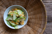 Fresh Chayote Fruits (Sechium Edulis) Stir Fried With Egg And Garlic In Bowl On Wood Background
