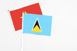 © sezerozger - Saint Lucia and Vietnam stick flags on white background. High quality fabric, miniature national flag. Peaceful global concept.White floor for copy space.
