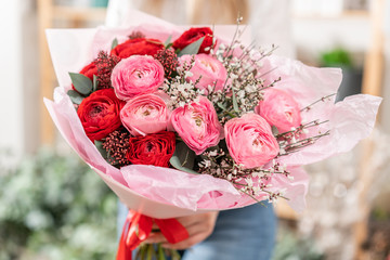 Beautiful bouquet of mixed flowers in womans hands. the work of the florist at a flower shop. Handsome fresh bouquet. Flowers delivery