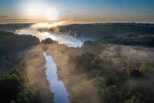 Aerial View Of Fog Over River With Rays In Autumn