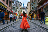 Fototapeta  - Woman standing at Galata tower in Istanbul, Turkey.