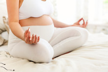 Beautiful Pregnant Woman Stretching And Practicing Yoga At Home