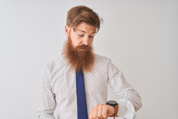 Wall Mural - Young redhead irish businessman standing over isolated white background Checking the time on wrist watch, relaxed and confident