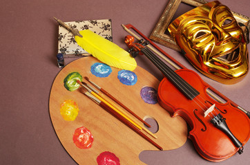 Attributes of the arts. Music, theater, literature, painting. Violin, theater mask, fountain pen, art palette.