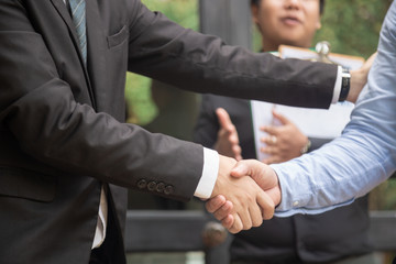 Business handshake in lofty office with city view, a deal is struck