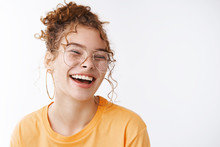 Carefree Joyful Happy Young Lucky Redhead Girl Wearing Glasses Messy Curly Bun Haircut Laughing Adore Awesome Funny Humor Jokes Standing Delighted White Background Grinning, White Background