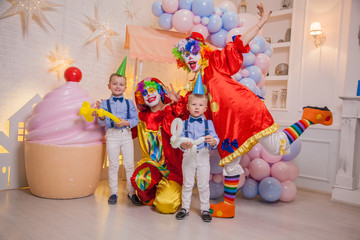 Wall Mural - Circus clowns at the birthday party. Boys and clowns. Party for children.