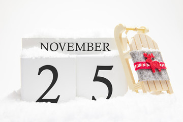 autumn calendar made of wooden cubes with the date of november 25, the concept of the first snow and