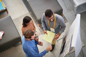 Man and woman customer with salesman in store furniture for the house