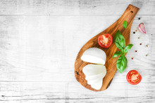 Fresh Finest Tomatoes On White Rustic Board With Basil And Mozzarella Cheese Top View.