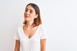 © Krakenimages.com - Beautiful redhead woman wearing casual white t-shirt over isolated background smiling looking to the side and staring away thinking.