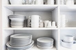 White Cupboard with white crockery in the kitchen, various clean dishes