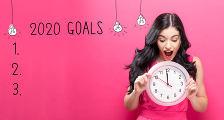 Canvas Print - 2020 goals with young woman holding a clock showing nearly 12