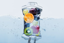Fruit Slices In Saline Bag Dipped In Water Against Background