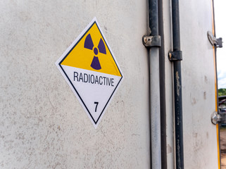 Wall Mural - Radiation warning sign on the transport label Class 7 at the Door of the transport truck container