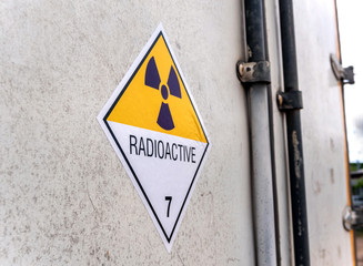 Wall Mural - Radiation warning sign on the transport label Class 7 at the Door of the transport truck container