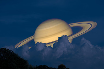 Wall Mural - Saturn on night sky back silhouette mountain and heap cloud