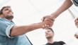© ASDF - colleagues shaking hands in the office lobby