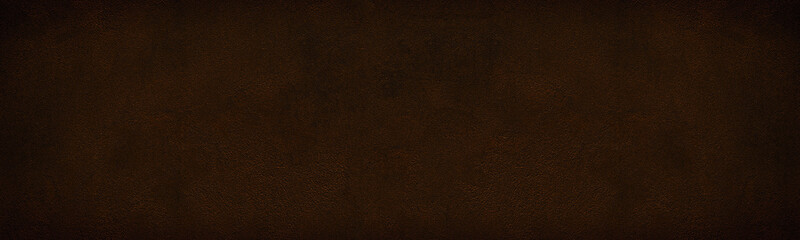 Wide dark bronze colored shabby cement plaster texture. Rough surface widescreen backdrop. Large grunge background