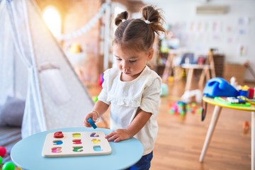 Poster - Young beautiful toddler learning mathematics playing with maths game at kindergaten