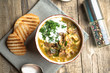 © Alexandr - Homemade soup with porcini mushrooms croutons and herbs on a light wooden background top view.