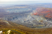 Aerial View Of Opencast Mining Quarry With Lots Of Machinery At Work - View From Above.