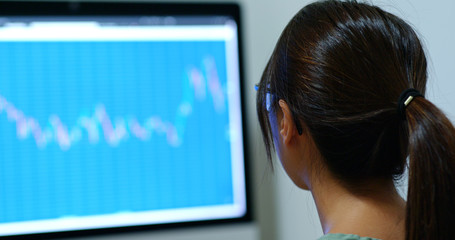 Wall Mural - Woman study on the stock market data in office