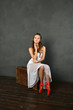 © константин константи - girl in a white transparent dress in red pointe shoes on a brown suitcase