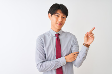 Wall Mural - Chinese businessman wearing elegant tie standing over isolated white background with a big smile on face, pointing with hand finger to the side looking at the camera.