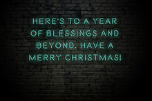 Neon Inscription Of Christmas And New Year Greetings On Brick Wall
