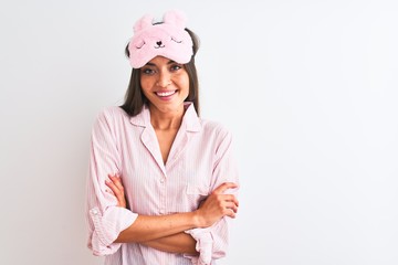 Poster - Young beautiful woman wearing sleep mask and pajama over isolated white background happy face smiling with crossed arms looking at the camera. Positive person.