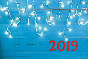 Wall Mural - 2019 hanging on teal blue sign with holiday lights border