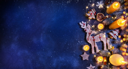 christmas background with wooden decorations and candles. free space for text