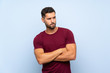 © luismolinero - Handsome man over isolated blue background with confuse face expression