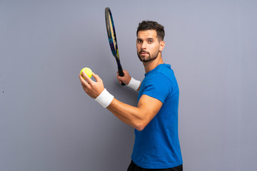 Handsome young tennis player man