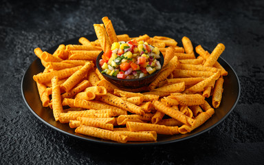 Wall Mural - cheddar cheese tortilla rolls, chips in serving basket with mango salsa