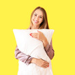 © Pixel-Shot - Beautiful young woman with pillow on color background