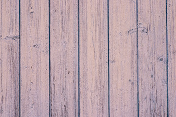 Wall Mural - The texture of the old wall of the house of wooden boards painted with pink paint. Peeling paint flakes