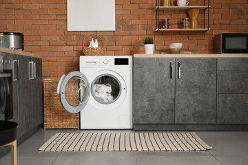 Interior of kitchen with modern washing machine