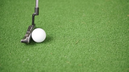 Wall Mural - Image of golf putter and golf ball on green grass