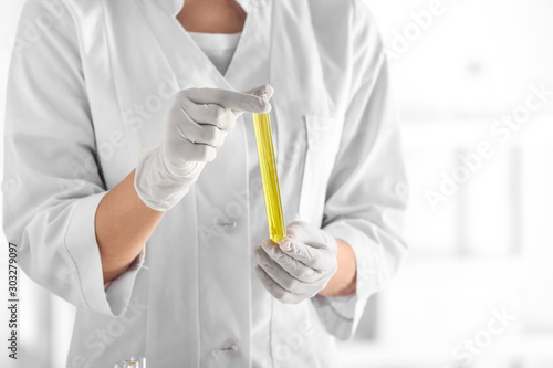 Scientist with test tube in laboratory