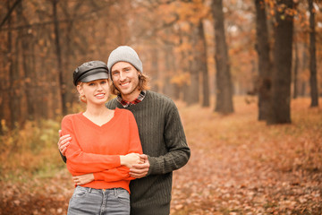 Wall Mural - Young couple in park on autumn day