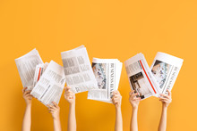 Female Hands With Newspapers On Color Background